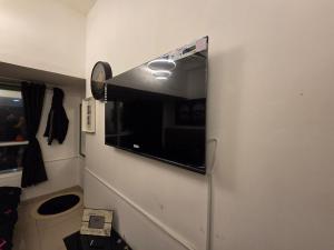 a television on a wall in a room at Ajman Central Downtown B-50018 in Ajman 