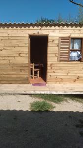 a wooden cabin with a bench inside of it at El Refugio in Santa Vitória do Palmar
