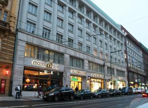 a large building with cars parked in front of it at Motel One Prague-Florentinum in Prague