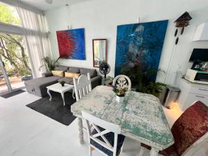 a living room with a table and a couch at fascinating loft with swimming pool in Oaxaca City