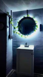 a bathroom with a sink and a mirror on the wall at The Mercedes Room in Oaxaca City