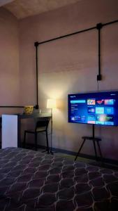 a projection screen in a room with a table and a chair at The Mercedes Room in Oaxaca City