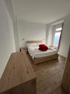 a bedroom with a bed and a wooden table at DAISY Air Conditioning - Free Parking - WiFi - Self Check-in in Bergamo