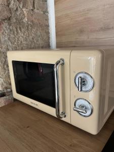 a microwave oven sitting on top of a counter at DAISY Air Conditioning - Free Parking - WiFi - Self Check-in in Bergamo