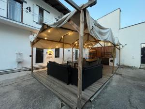 a large umbrella on a deck in front of a building at DAISY Air Conditioning - Free Parking - WiFi - Self Check-in in Bergamo