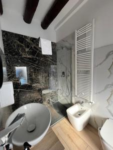 a bathroom with a sink and a toilet at DAISY Air Conditioning - Free Parking - WiFi - Self Check-in in Bergamo +37 photos