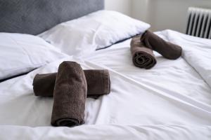 a pair of brown socks and boots on a bed at Birdhouse Apartments in Prešov