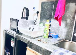 a kitchen counter with a sink and a microwave at B&S Studio apartment 1 , Voi Town in Voi