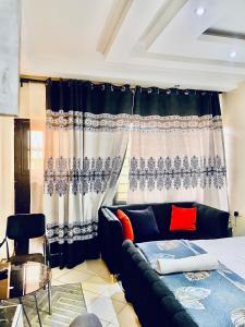 a living room with a couch in front of a window at B&S Studio apartment 1 , Voi Town in Voi