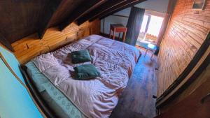an overhead view of a bed with two pillows on it at Bunker Hostel in Cabo Polonio