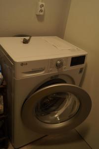 a washing machine with a white counter on top of it at Domek nad Narwią in Zatory