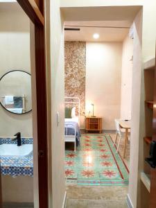a hallway with a bedroom with a bed and a bathroom at Villa Lara Palacios, tu oasis en Mérida in Mérida +27 photos