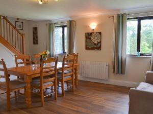 a dining room with a table and chairs at Rosecraddoc Manor - Lakeview in Saint Cleer