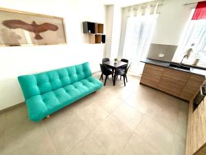 a living room with a blue couch and a table at Italy House in Ladispoli