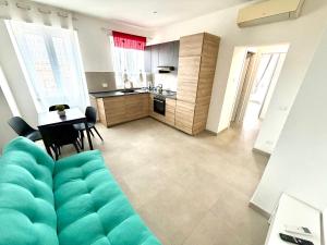 a living room with a couch and a kitchen at Italy House in Ladispoli