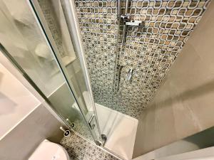 a shower with a glass door next to a toilet at Italy House in Ladispoli +23 photos