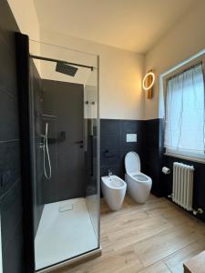 a bathroom with a shower and a toilet and a sink at Luisella house in Isola Sacra +13 photos
