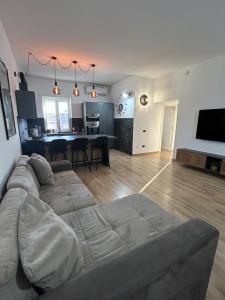 a living room with a couch and a table at Luisella house in Isola Sacra