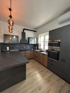a large kitchen with a stove and a counter top at Luisella house in Isola Sacra