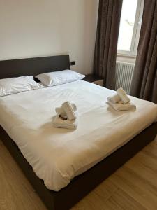 a bedroom with a bed with towels on it at Luisella house in Isola Sacra