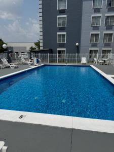 a large blue swimming pool in front of a building at Quality Inn & Suites CVG Airport in Erlanger