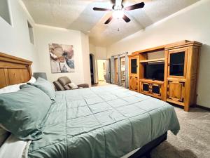 a bedroom with a bed and a flat screen tv at Spacious Home in Page