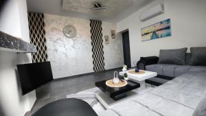 a living room with a couch and a table at Crassula Lux 4 in Surčin