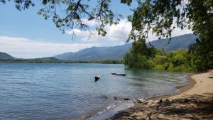 a body of water with a boat in it at Arche Noah in Kalabahi