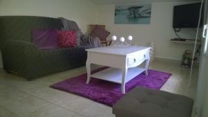 a living room with a white table and a couch at Apartamento Teixeira 2 in Arco da Calheta
