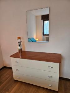 a dresser with a mirror on top of it at Ai Volardi Apartment in Torre di Santa Maria