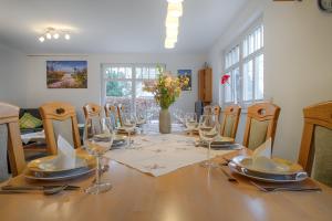a dining room with a table with wine glasses at FH Luisenlund im Ostseebad Prerow in Prerow