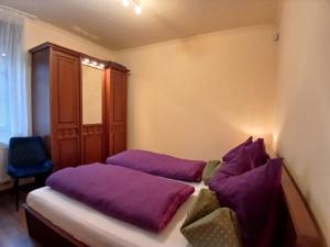 a bedroom with two purple pillows on a bed at Mami Apartman in Zalakaros