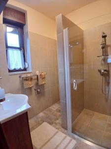 a bathroom with a shower and a sink at Mami Apartman in Zalakaros +12 photos