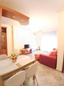 a living room with a dining table and a bedroom at Mami Apartman in Zalakaros