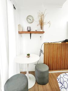 a room with a table and two stools and a clock at Best 10th floor Condo Studio at The Loop Limketkai Center Lucky 4 in Cagayan de Oro