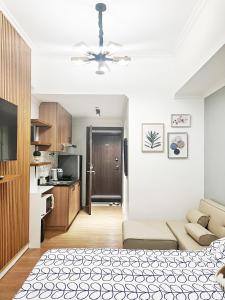 a living room with a bed and a kitchen at Best 10th floor Condo Studio at The Loop Limketkai Center Lucky 4 in Cagayan de Oro