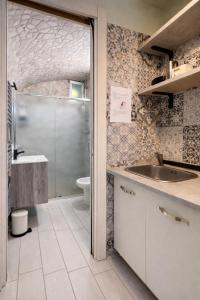 a bathroom with a shower and a sink and a toilet at Domus Flavia in Pozzuoli