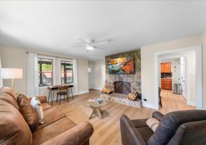 a living room with a couch and a fireplace at Hill Top Forest Cabin with Hot Tub, Fire Pit & Screened Porch in Pigeon Forge