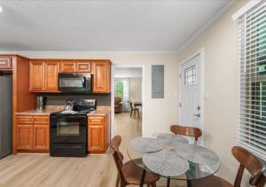 a kitchen and dining room with a table and chairs at Hill Top Forest Cabin with Hot Tub, Fire Pit & Screened Porch in Pigeon Forge