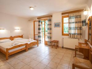 a bedroom with two beds and a window at LAURA Skiathos in Skiathos