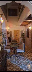 a room with tables and chairs in a building at Dar Manzakin in Marrakesh