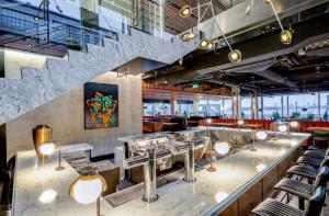 a restaurant with chairs and a staircase in the background at Modern Bright Suite Self Check-In in North Vancouver