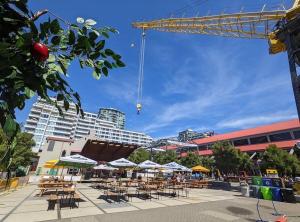 a patio with tables and chairs and a crane at Modern Bright Suite Self Check-In in North Vancouver