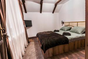 a bedroom with a bed and a television in it at Cabana lui Matei in Borlova