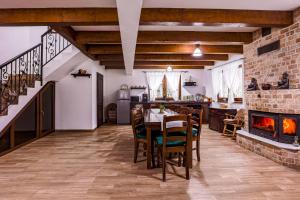a dining room with a table and a fireplace at Cabana lui Matei in Borlova