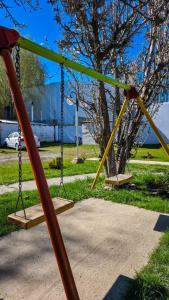 an empty swing set in a park at Cabañas Matices in El Calafate