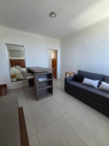 a living room with a couch and a desk at Espacio 43 Terminal in La Plata