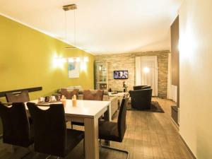 a dining room and living room with a table and chairs at Casa Leonardo in Göhren-Lebbin