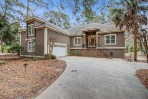 a house with a driveway and palm trees at Baywood 3074 in Seabrook Island