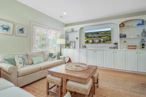 a living room with a couch and a table at Baywood 3074 in Seabrook Island +37 photos